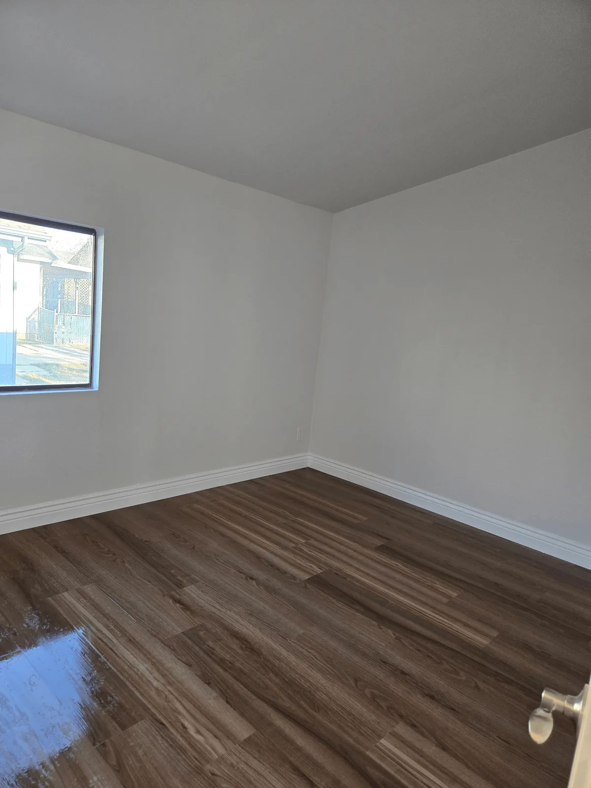 Empty bedroom with clean floors after a Shiny Go Clean appointment