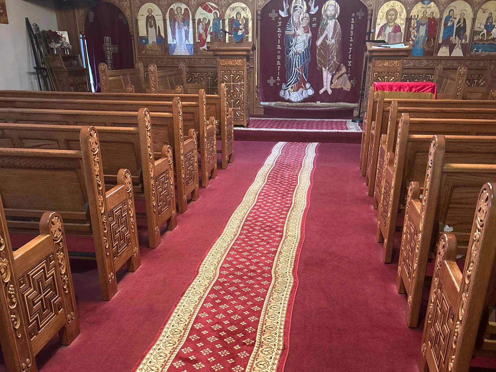 Clean center aisle and wooden pews inside a Sun Prairie church